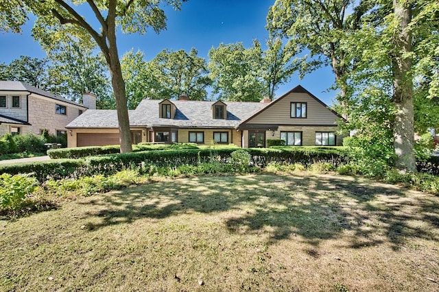 6776 N Laporte Ave, Lincolnwood, IL 60712 - view of front of house with an attached garage, a front yard, a chimney, and brick siding