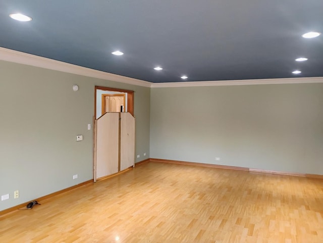 empty room featuring ornamental molding and baseboards
