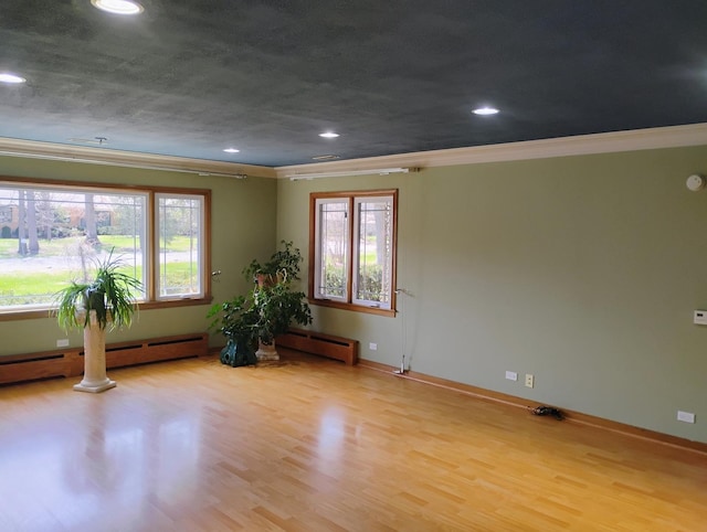 spare room with recessed lighting, ornamental molding, and wood finished floors