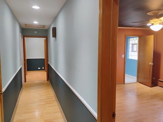 hallway featuring light wood-style flooring, recessed lighting, and baseboards