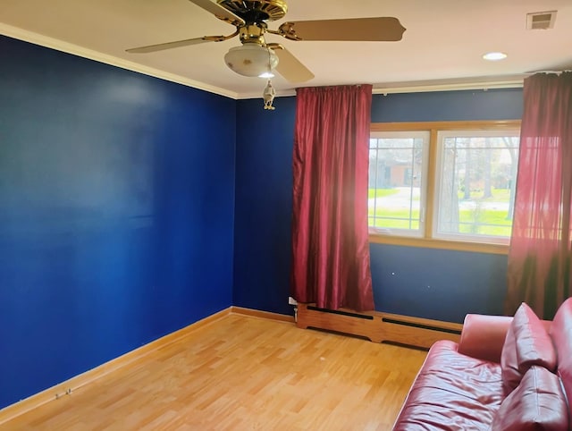 living area featuring crown molding, visible vents, ceiling fan, and wood finished floors