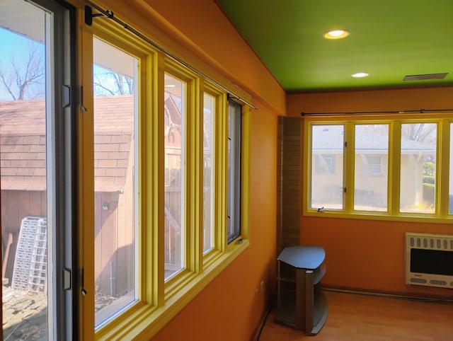 interior space with visible vents and heating unit