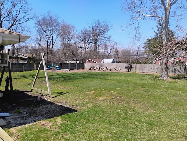 view of yard featuring a fenced backyard and a playground