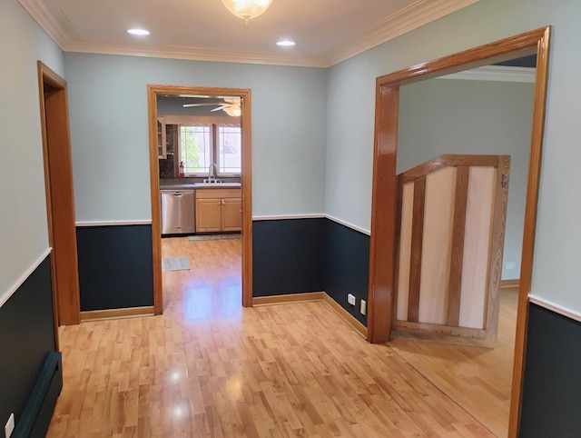 corridor with recessed lighting, light wood-style floors, a sink, and crown molding