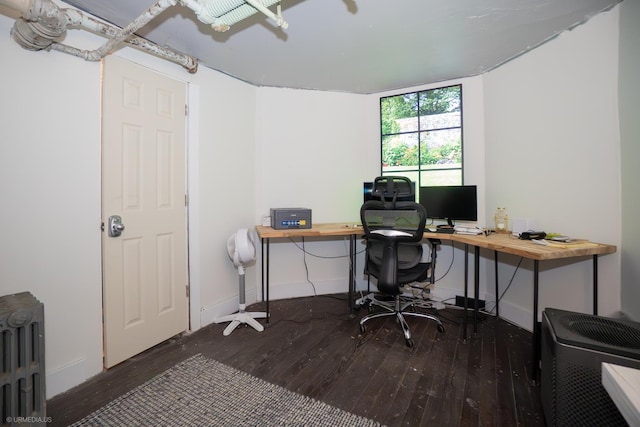office space with wood-type flooring, radiator heating unit, and baseboards