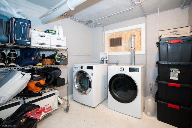 clothes washing area featuring washer and dryer