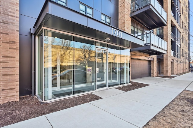 1701 W Webster Ave Unit 512, Chicago, IL 60614 - entrance to property featuring concrete driveway, a garage, and brick siding