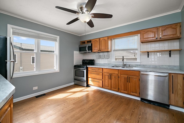 610 E Lemoyne Ave, Lombard, IL 60148 - kitchen featuring visible vents, a sink, ornamental molding, appliances with stainless steel finishes, and light wood finished floors