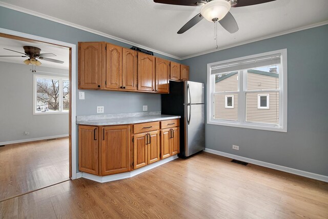 610 E Lemoyne Ave, Lombard, IL 60148 - kitchen featuring light wood-style flooring, light countertops, freestanding refrigerator, visible vents, and ceiling fan