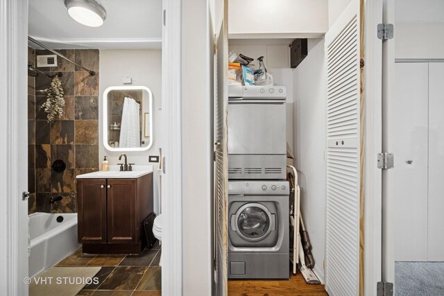 222 E Pearson St Unit 409, Chicago, IL 60611 - laundry area featuring stacked washer and dryer and a sink