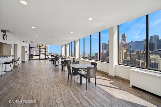 222 E Pearson St Unit 409, Chicago, IL 60611 - dining room with a city view, wood finished floors, baseboards, and recessed lighting