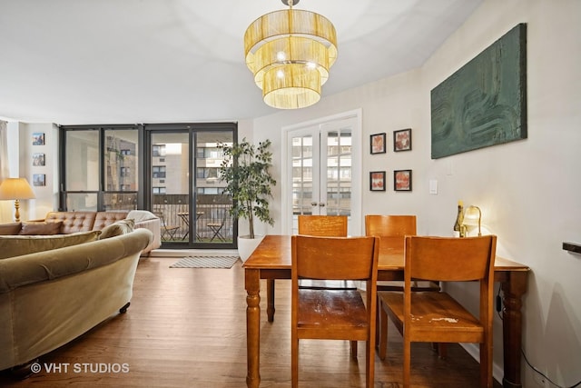 222 E Pearson St Unit 409, Chicago, IL 60611 - dining space with french doors, wood finished floors, and an inviting chandelier