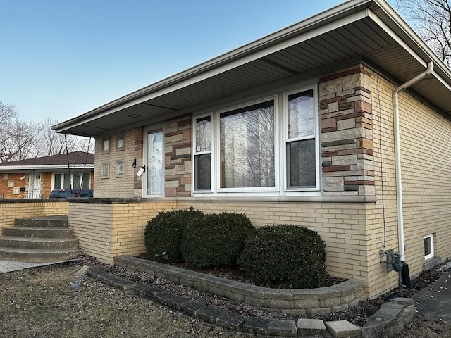 view of side of property with brick siding