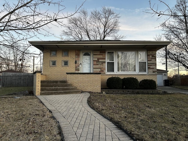 view of front of house with brick siding and fence