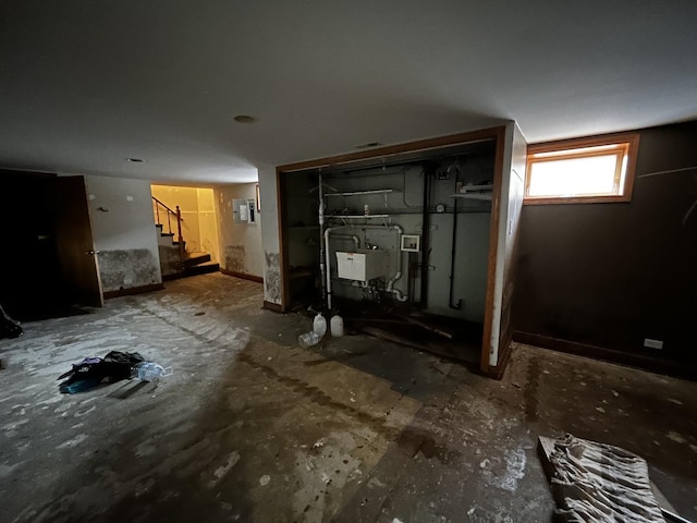 basement featuring stairway and electric panel