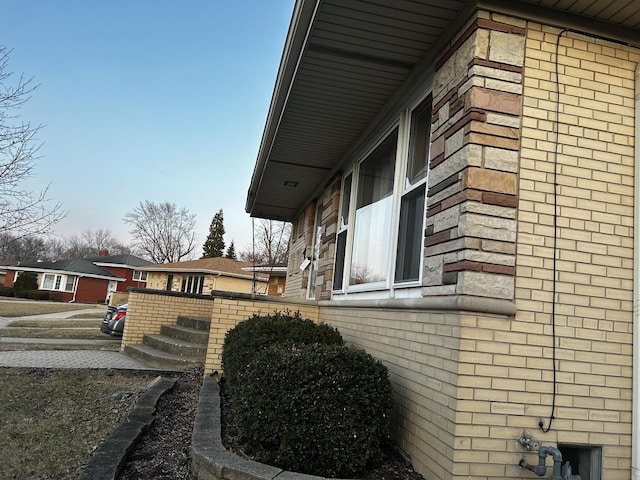 view of property exterior featuring brick siding and a residential view