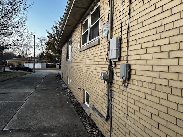 view of side of home with brick siding