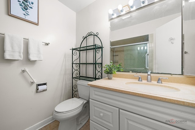 bathroom featuring tile patterned flooring, vanity, an enclosed shower, and toilet