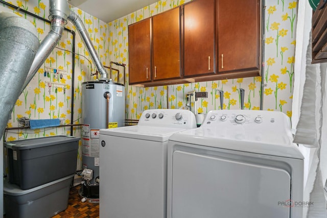 washroom featuring wallpapered walls, gas water heater, cabinet space, and washing machine and dryer