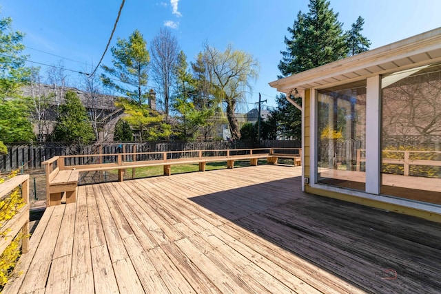 wooden deck with a fenced backyard