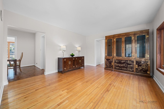 interior space featuring light wood finished floors and baseboards