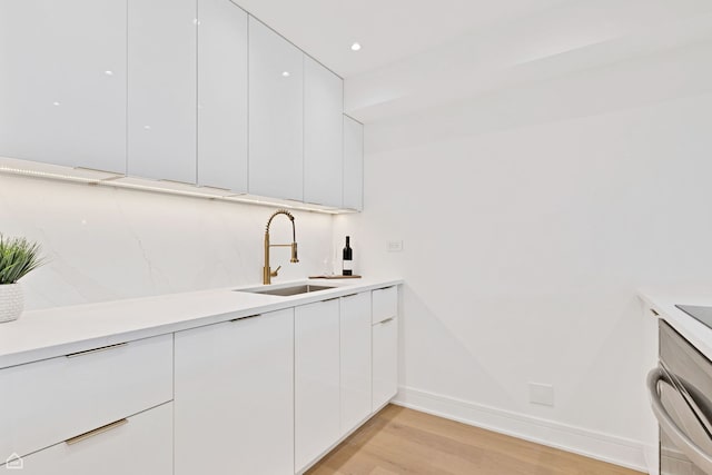 1560 N Sandburg Ter Unit 1011J, Chicago, IL 60610 - kitchen with white cabinets, light countertops, modern cabinets, and a sink