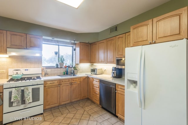 110 S Dunton Ave Unit 2A, Arlington Heights, IL 60005 - kitchen featuring white appliances, under cabinet range hood, light countertops, decorative backsplash, and light tile patterned floors