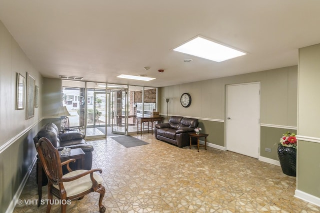 110 S Dunton Ave Unit 2A, Arlington Heights, IL 60005 - living area with floor to ceiling windows, a decorative wall, and a skylight