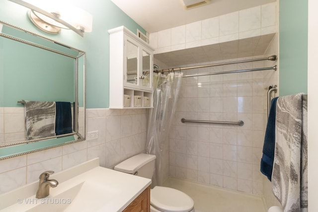 110 S Dunton Ave Unit 2A, Arlington Heights, IL 60005 - bathroom with vanity, a tile shower, tile walls, and tasteful backsplash