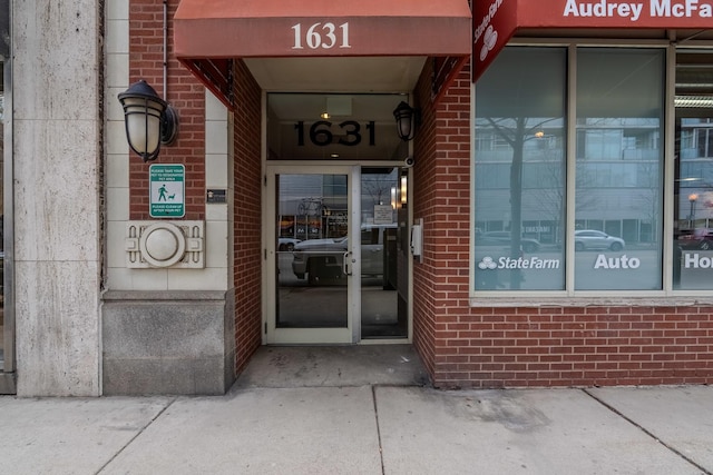 property entrance with brick siding