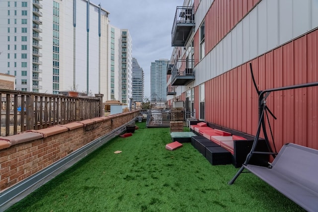 surrounding community featuring a city view, a yard, and an outbuilding