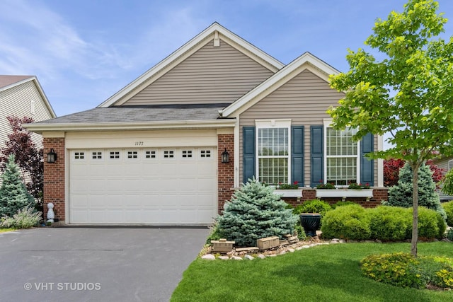 1177 Heathrow Ln, Aurora, IL 60502 - view of front facade featuring driveway, brick siding, and a garage