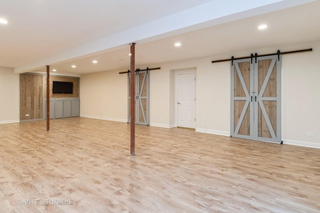 1177 Heathrow Ln, Aurora, IL 60502 - basement featuring a barn door, wood finished floors, and recessed lighting
