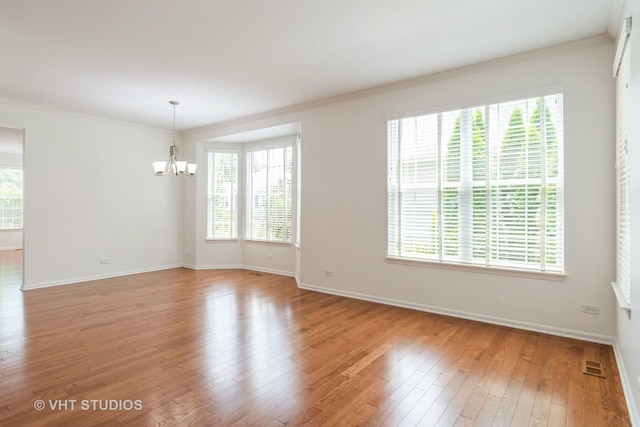 1177 Heathrow Ln, Aurora, IL 60502 - empty room featuring a chandelier, light wood-type flooring, and ornamental molding