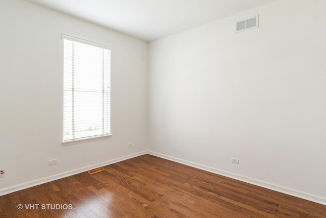 1177 Heathrow Ln, Aurora, IL 60502 - spare room featuring dark wood finished floors and plenty of natural light