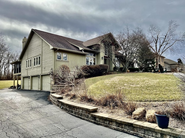 38W715 Bonnie Ct, Saint Charles, IL 60175 - view of property exterior with a shingled roof, a lawn, a garage, a chimney, and driveway