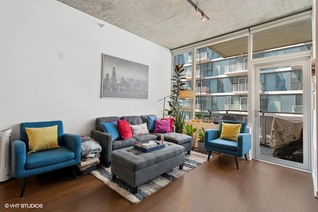 sitting room featuring track lighting, wood finished floors, and floor to ceiling windows