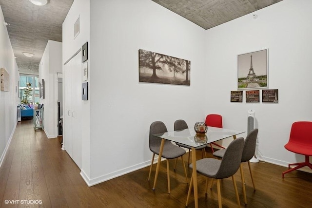 dining area featuring hardwood / wood-style floors, baseboards, and visible vents