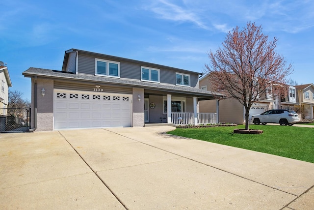traditional-style house featuring driveway, a front lawn, brick siding, a garage, and covered porch