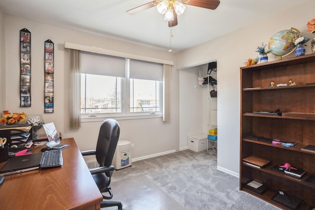 office space featuring baseboards, a ceiling fan, and carpet flooring
