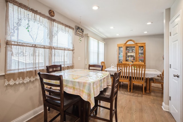 dining area featuring recessed lighting, baseboards, and wood finished floors