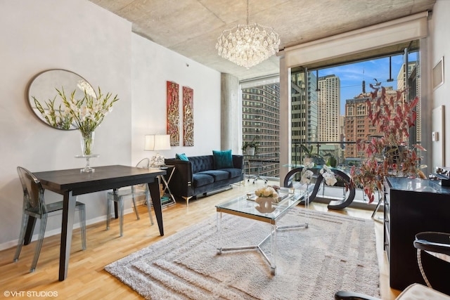 living room featuring a city view, a chandelier, wood finished floors, and a healthy amount of sunlight