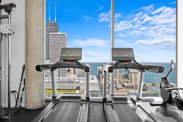 gym with a view of city and a water view