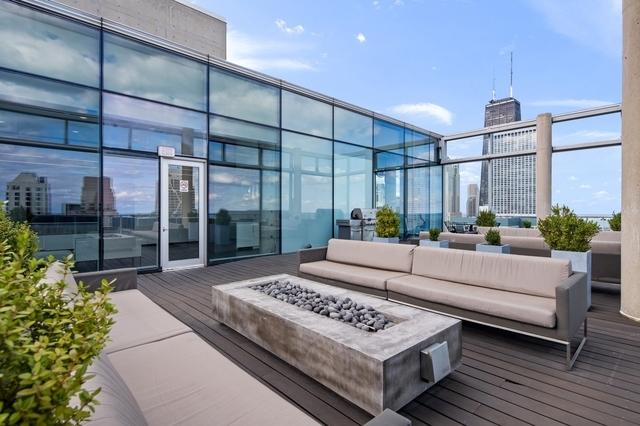 exterior space with a city view and an outdoor living space with a fire pit