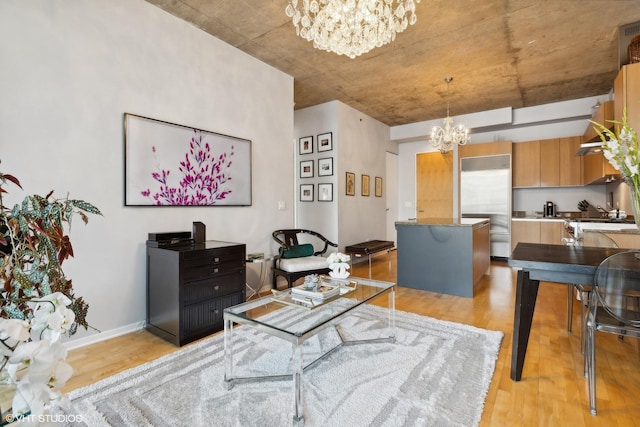interior space featuring baseboards, light wood finished floors, and a notable chandelier