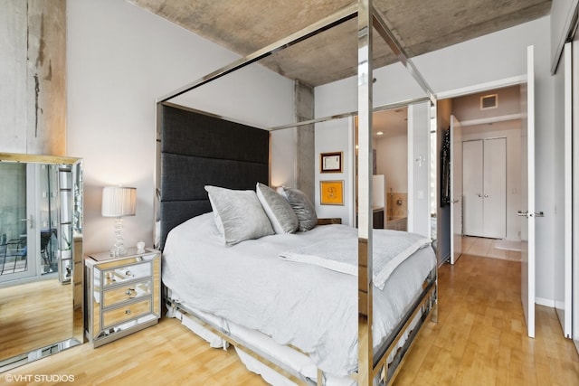 bedroom with visible vents and light wood-type flooring