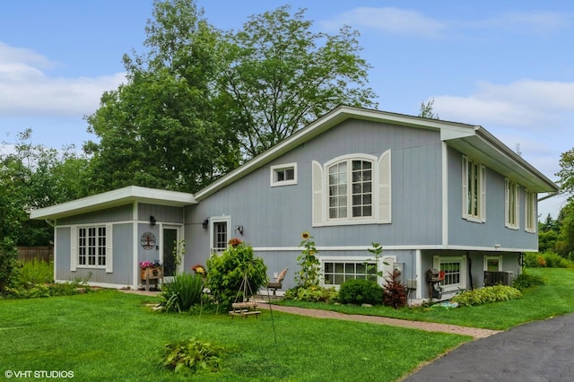 rear view of property featuring a lawn