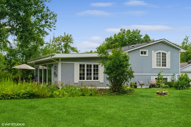 back of house with a lawn
