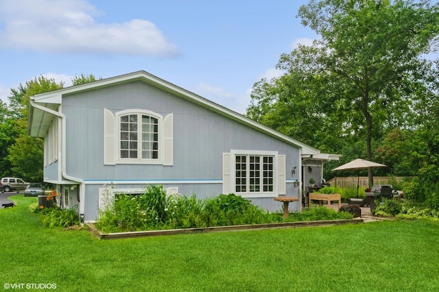 rear view of house with a lawn