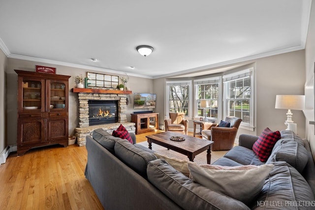 living room featuring a stone fireplace, light wood-style floors, and ornamental molding